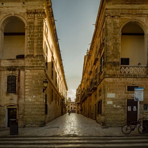 A stone street at dusk in Spain.