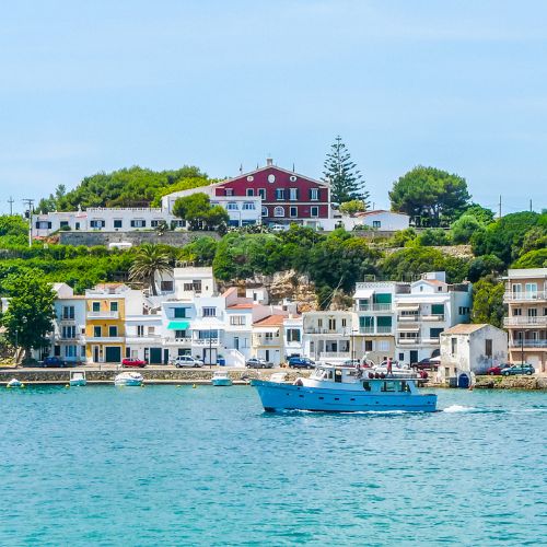 A seaside town with a boat sailing