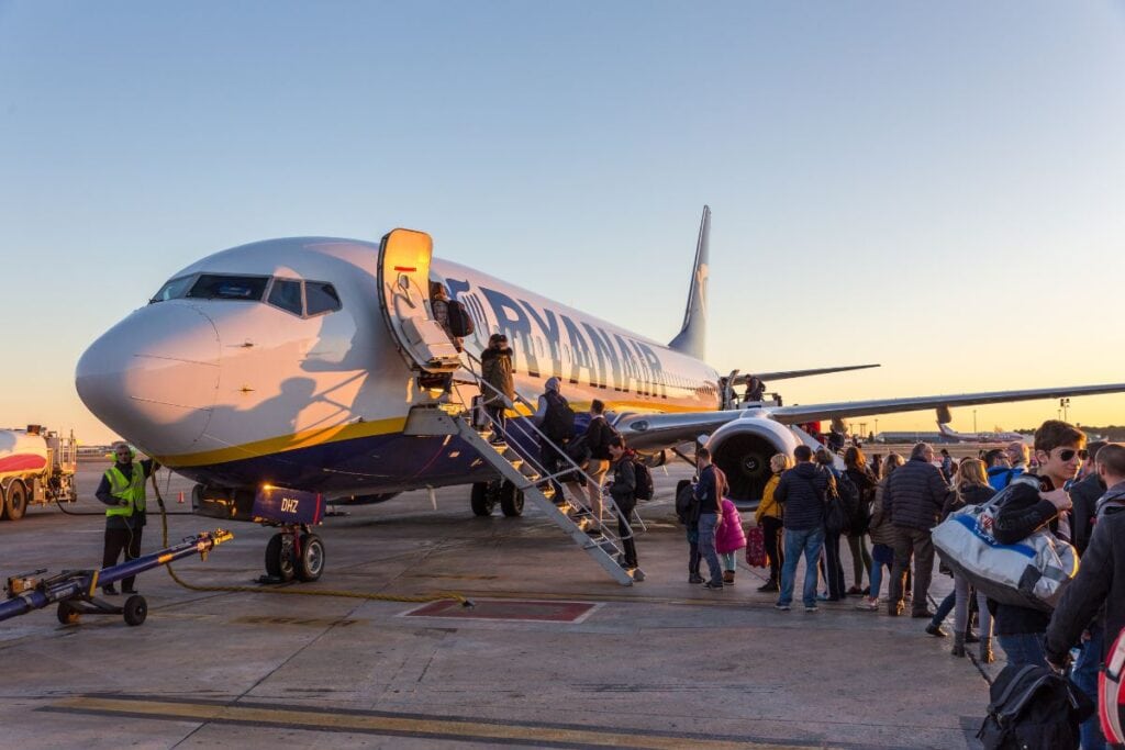 A large airplane parked on the tarmac, ready for takeoff to destinations like Madrid.