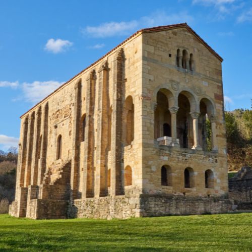 An old stone building in a field.