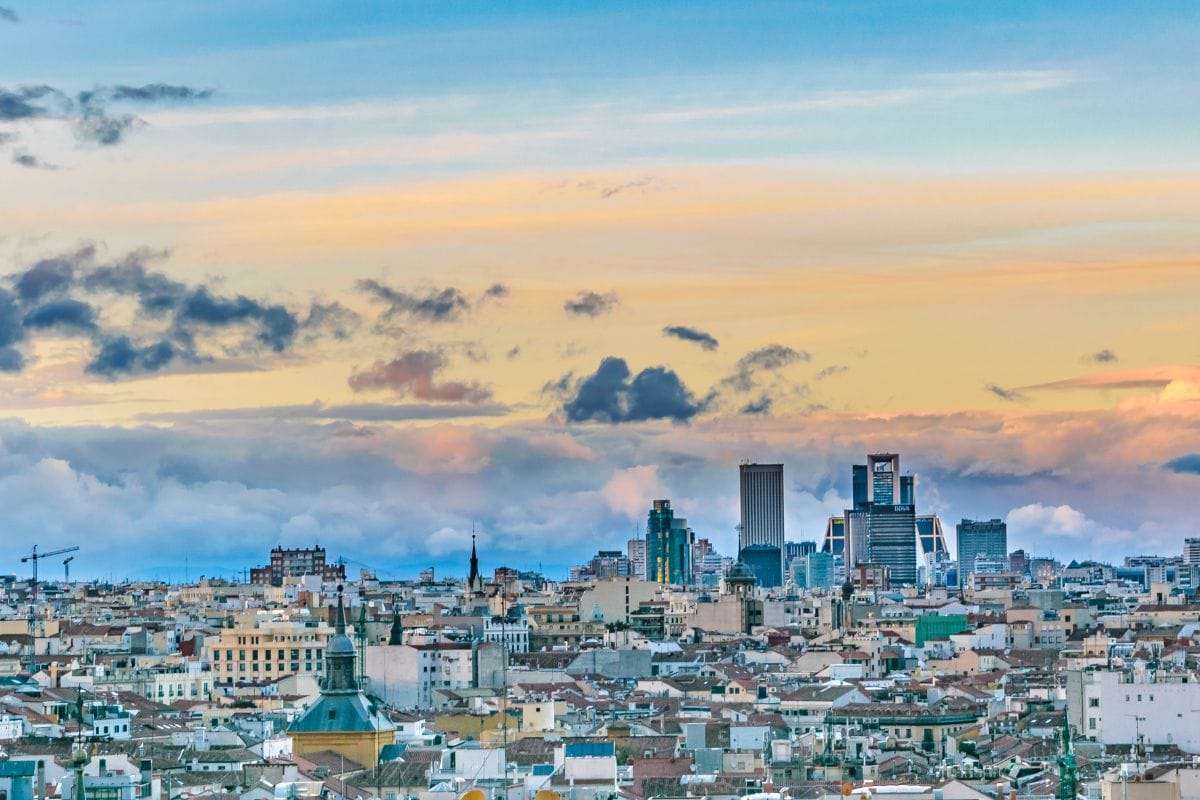 Madrid skyline at sunset, showcasing vibrant colors and iconic architecture, perfect for travelers planning their trip.