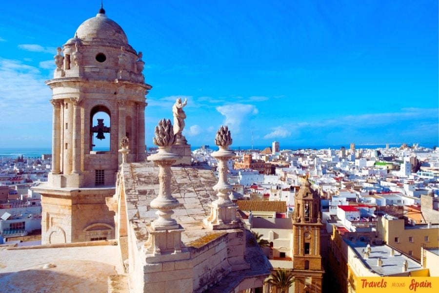 View of the Cádiz skyline with a historic tower in the foreground, showcasing one of the best places to visit in Spain for first-time travelers.