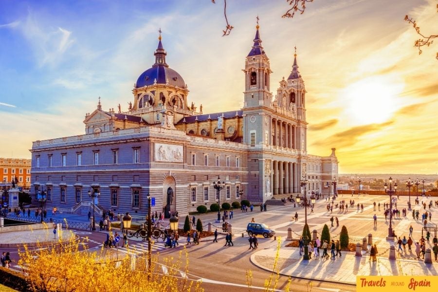 The Royal Palace in Madrid, Spain, glowing at sunset with its grand architecture illuminated — a stunning landmark that makes Madrid one of the best places to visit in Spain for first timers.