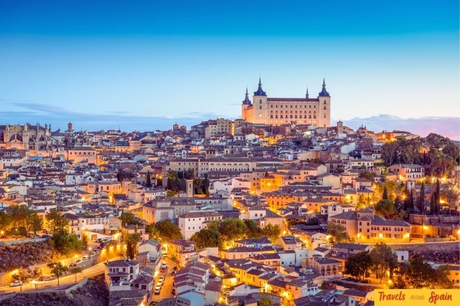 Aerial view overlooking the historic city of Toledo with a landmark building on the hill, a must-visit cultural destination in Spain for first-time travelers.