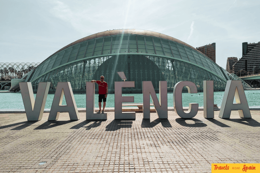 A tourist standing in front of the Valencia sign at the City of Arts and Sciences — a top attraction in one of the best places to visit in Spain for first-timers.
