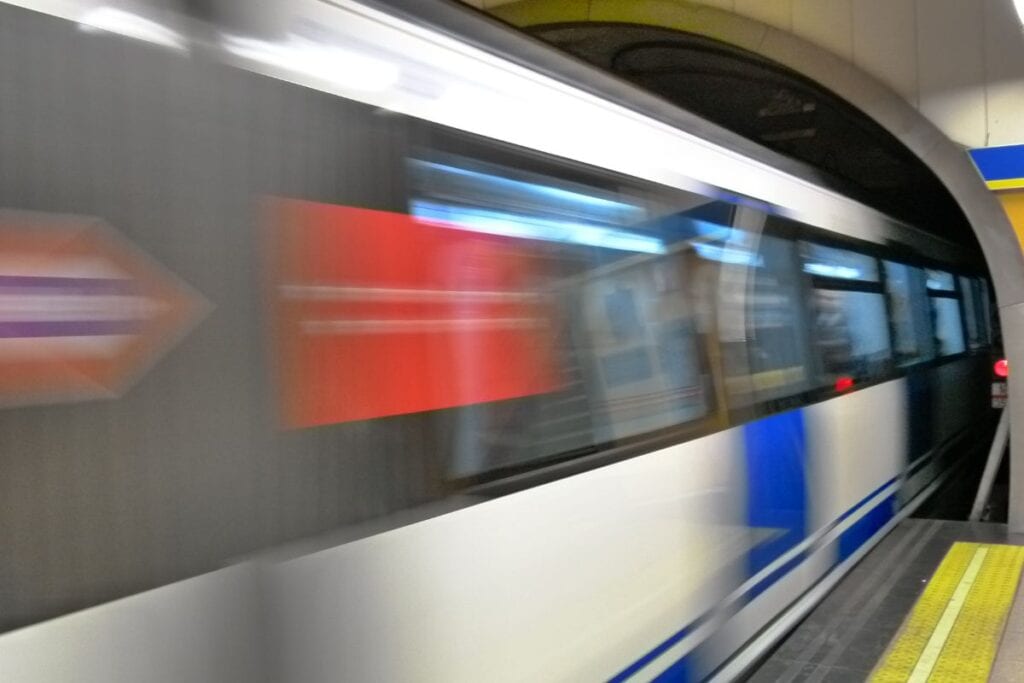 Madrid Metro platform with a train arriving.