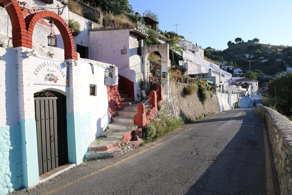 Traditional whitewashed cave houses built into the hillside of Sacromonte, Granada — a distinctive option for where to stay in Granada, Spain, known for flamenco and historic charm.