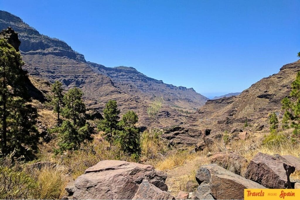 Gran Canaria dramatic mountain valley showing volcanic landscape with clear blue skies, perfect for hiking adventures during moderate weather months.