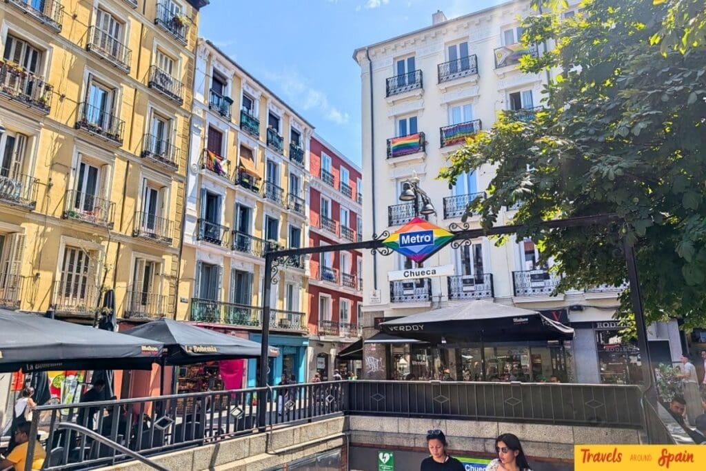 Madrid Chueca metro station entrance with rainbow colored sign in gay neighborhood