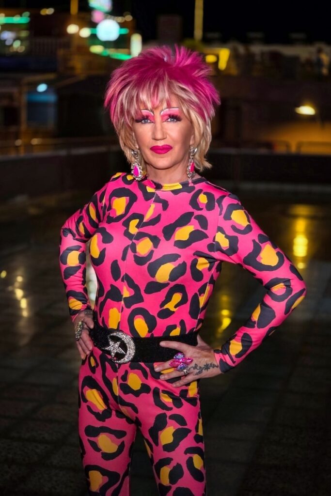 Dinah Might drag queen in pink leopard print outfit with blonde spiky hair at Sparkles Bar Maspalomas