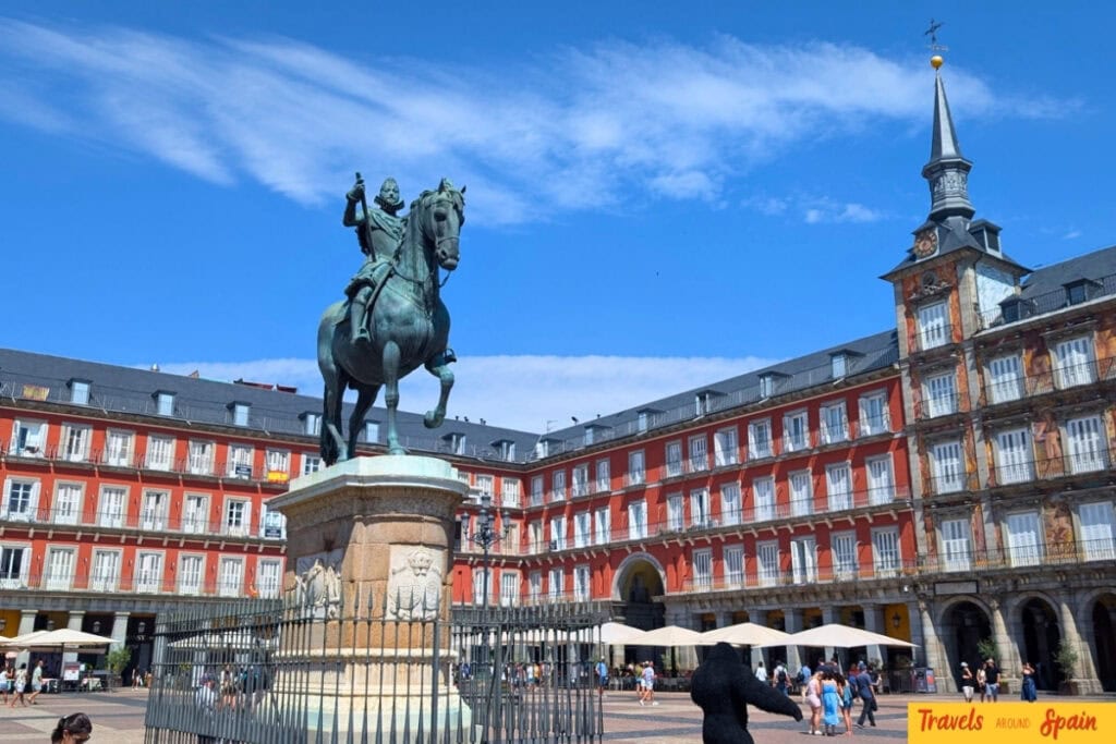 Plaza Mayor Madrid showing historic red buildings and Philip III statue