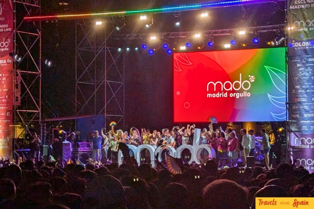 Madrid Pride MADO stage with rainbow lighting and performers during LGBT celebrations in Spain