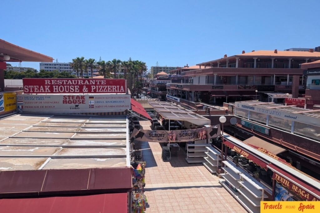 Multilingual restaurant signs in Gran Canaria tourist area showing English and European language options