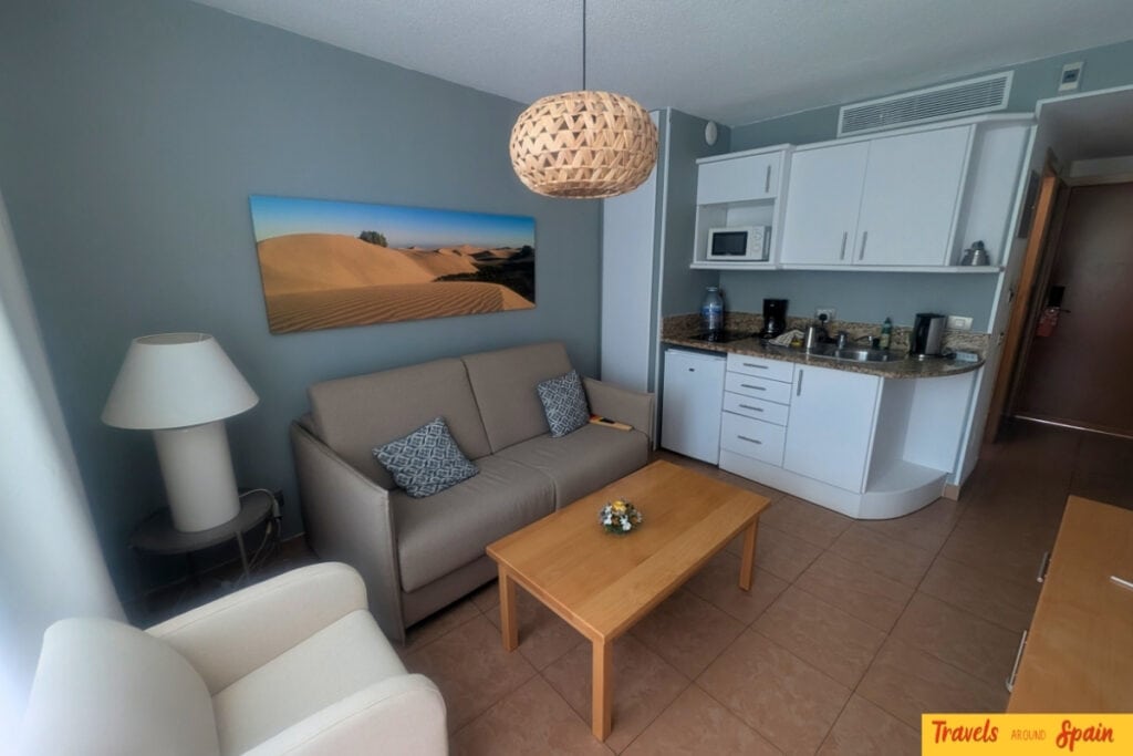 Modern living room and fully-equipped kitchenette at Mur Apartments Buenos Aires with pool view balcony