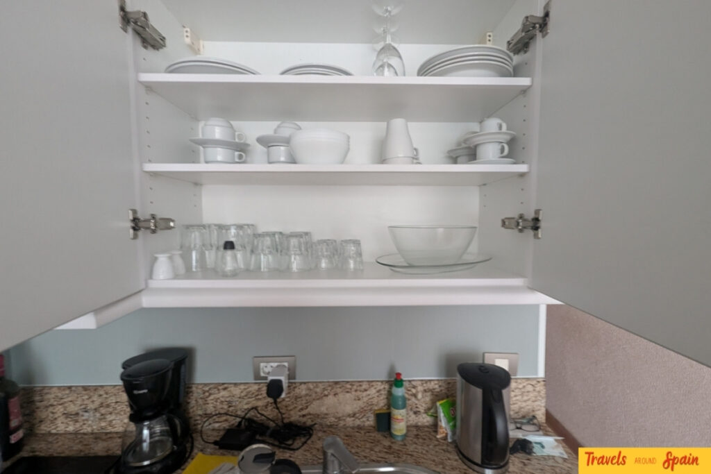 Well-stocked kitchen cupboards showing crockery, glasses and cooking equipment at Mur Apartments Buenos Aires