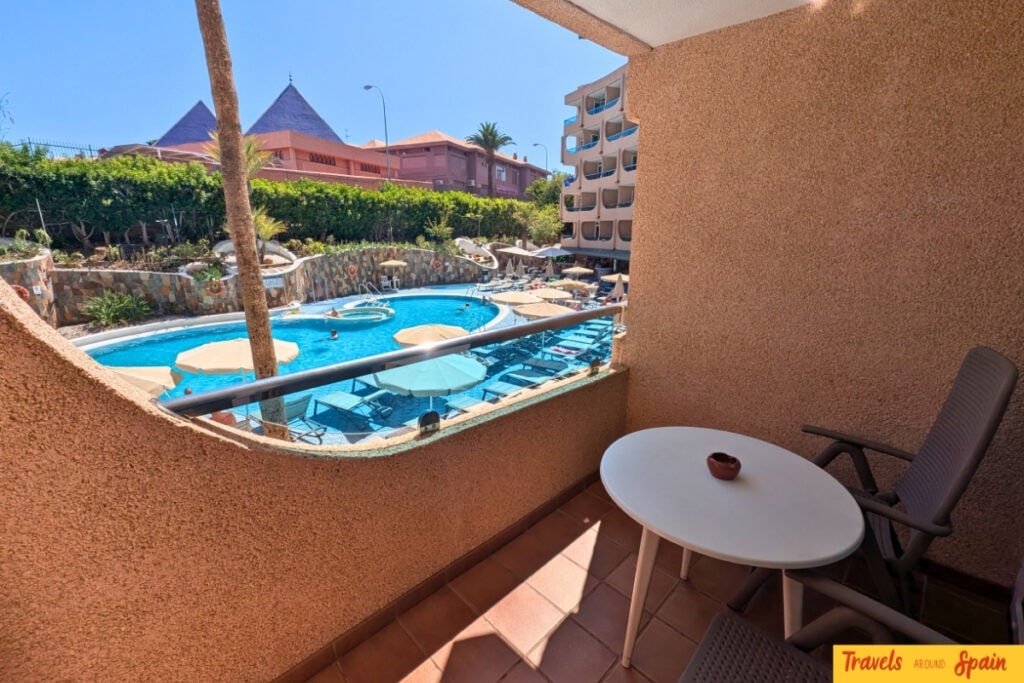Private balcony with outdoor furniture overlooking the pool at Mur Apartments Buenos Aires
