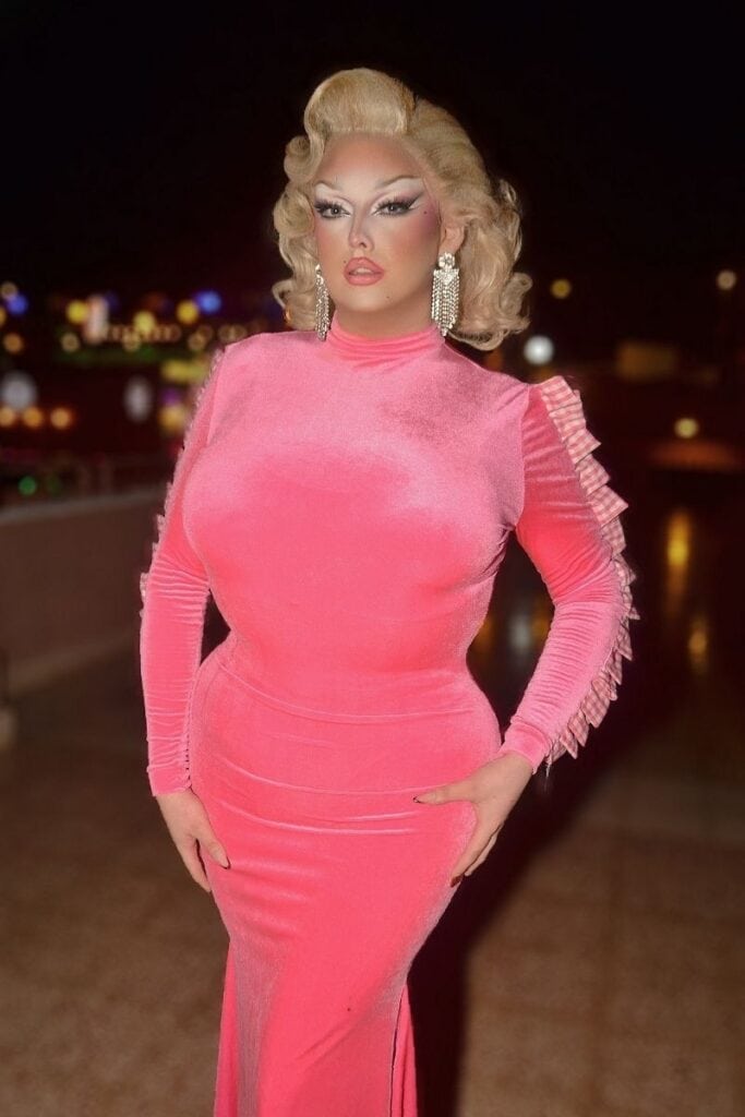 Polly Glamurous drag queen in pink ruched dress with blonde vintage curls at Sparkles Bar Maspalomas