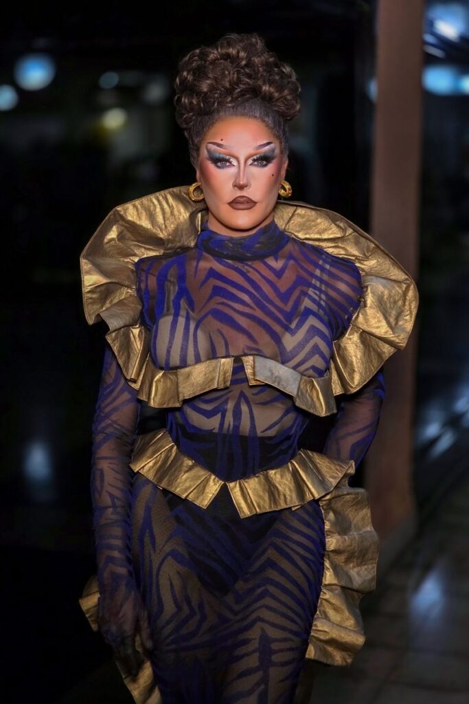 Queen Queef drag queen in elaborate blue and gold geometric outfit at Sparkles Bar Maspalomas