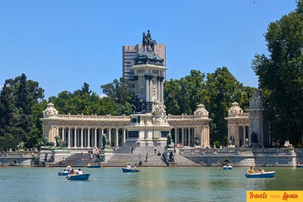 Retiro Park boating lake Madrid with Alfonso XII monument and rowboats