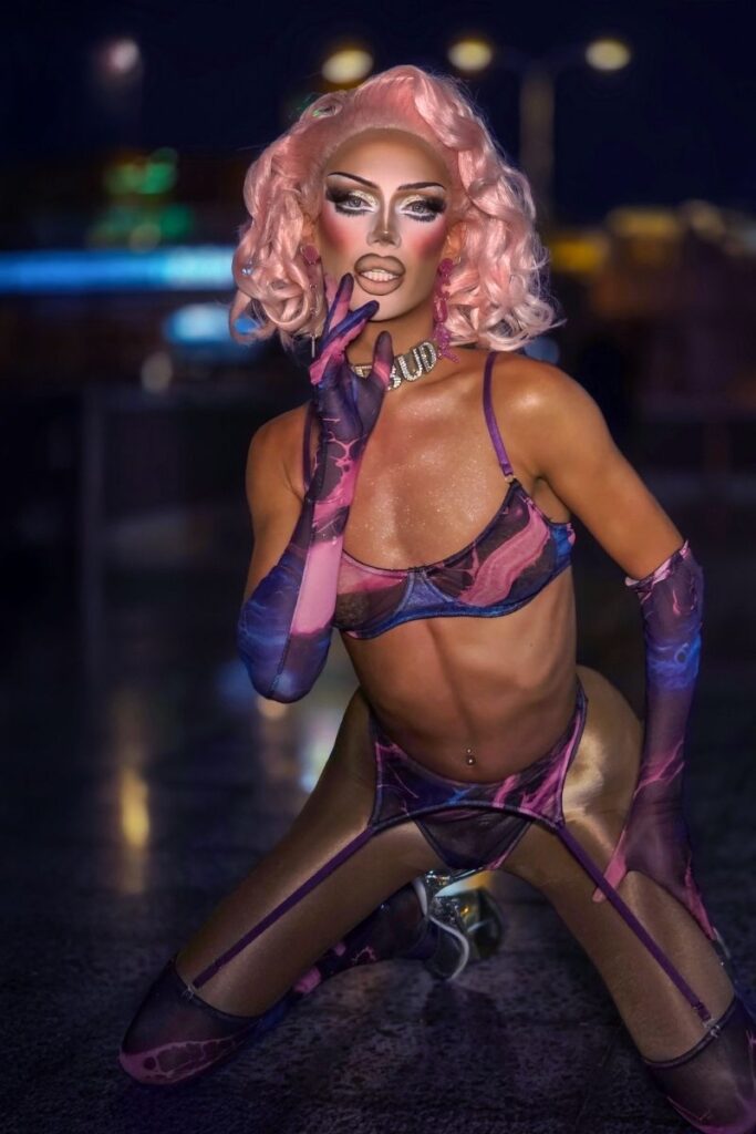 Rosebud drag queen in pink and purple outfit with pink hair at Sparkles Bar Maspalomas