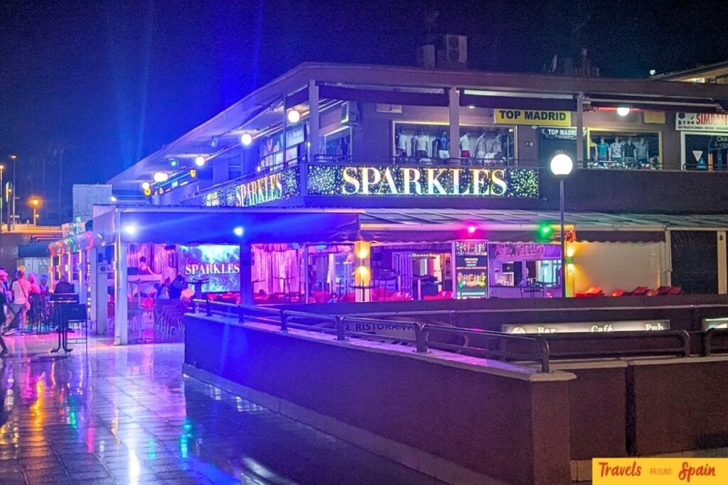 Sparkles drag show venue exterior with colorful lighting at night in Yumbo Centre