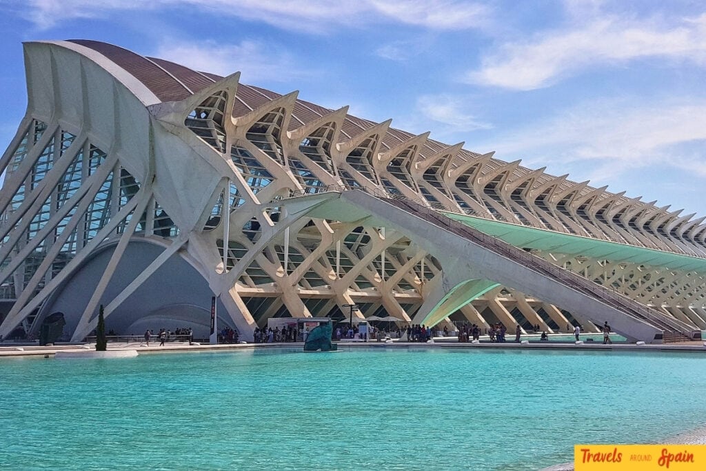 Modern white skeletal architecture of the Príncipe Felipe Science Museum in Valencia resembling a whale skeleton with blue reflective pools