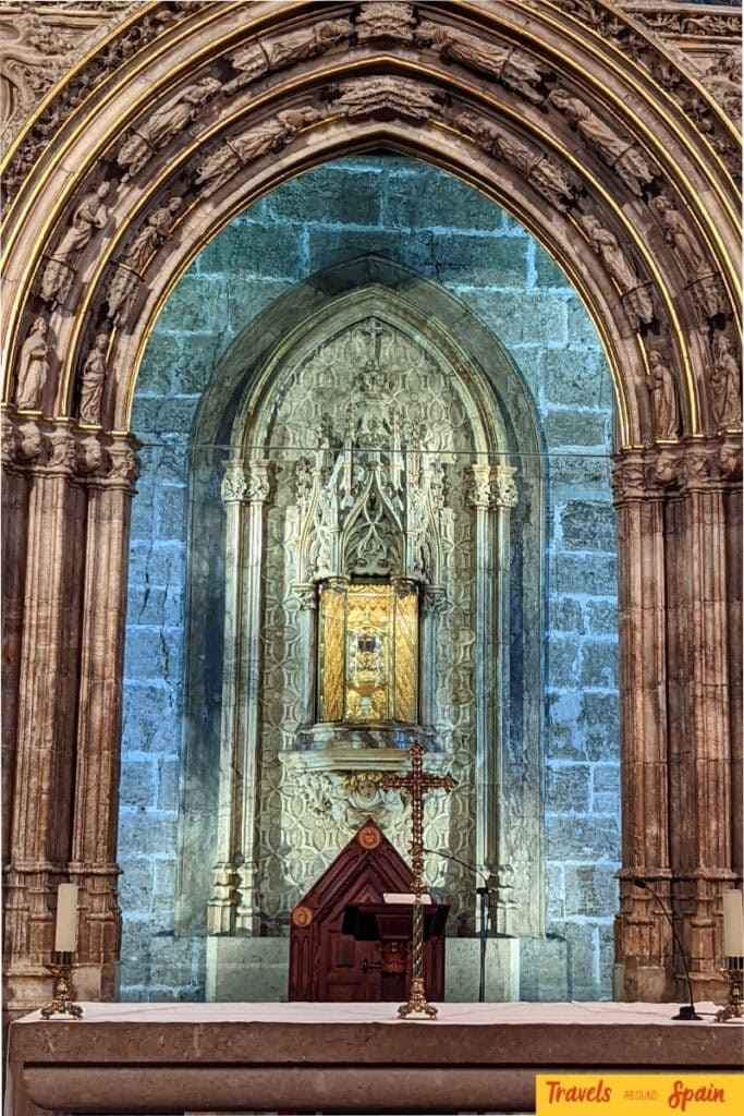 Ornate Gothic interior of Valencia Cathedral showing the chapel that houses the Holy Grail with detailed stone architecture.