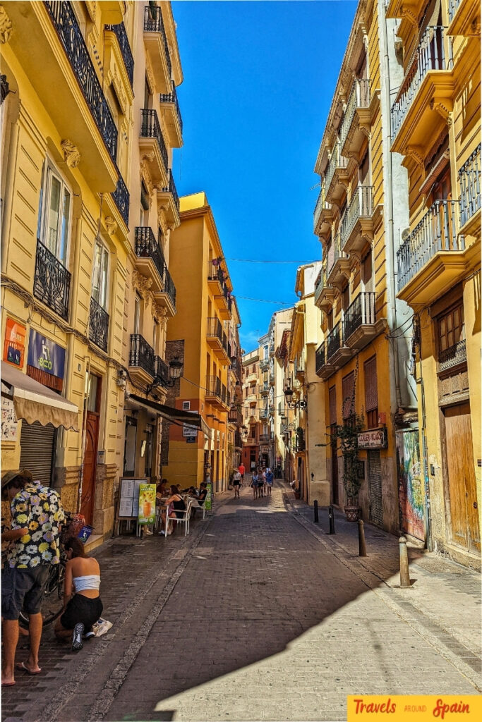 Narrow medieval street in Valencia's Old Town showing traditional architecture with colourful buildings and historic facades