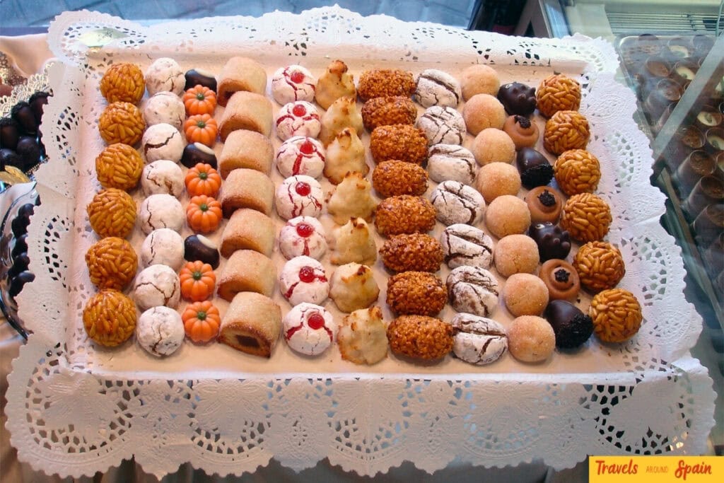 All Saints Day Spain panellets and traditional pastries on bakery tray