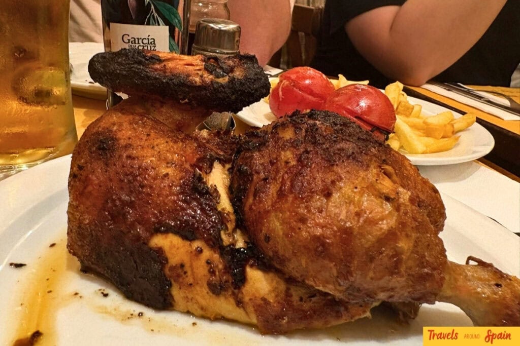 Rotisserie chicken with crispy skin served at La Oca in Sitges.