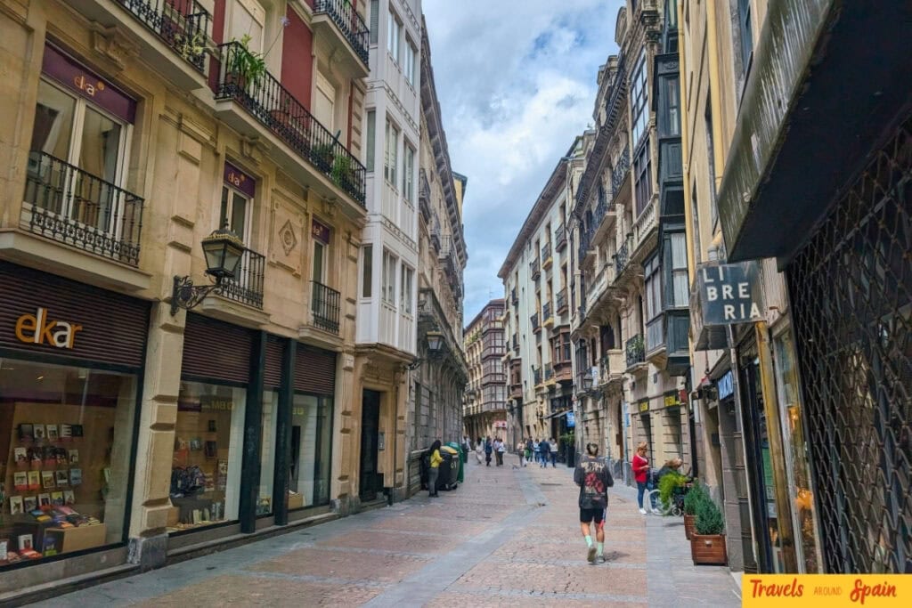 Historic street in Bilbao old town with people walking on a September afternoon