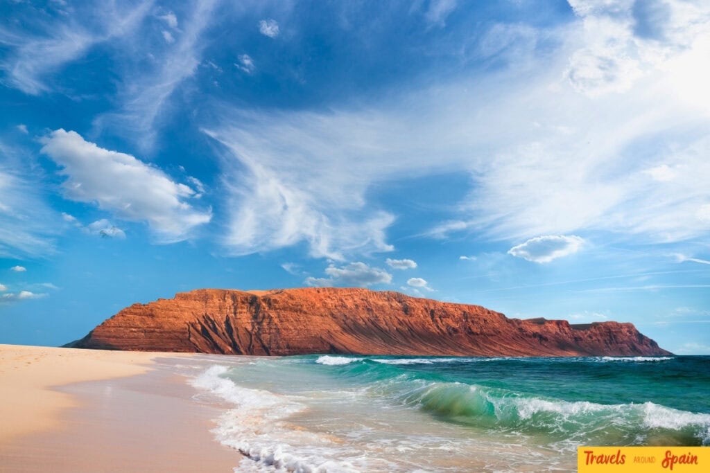 Sandy beach in the Canary Islands with blue water in September