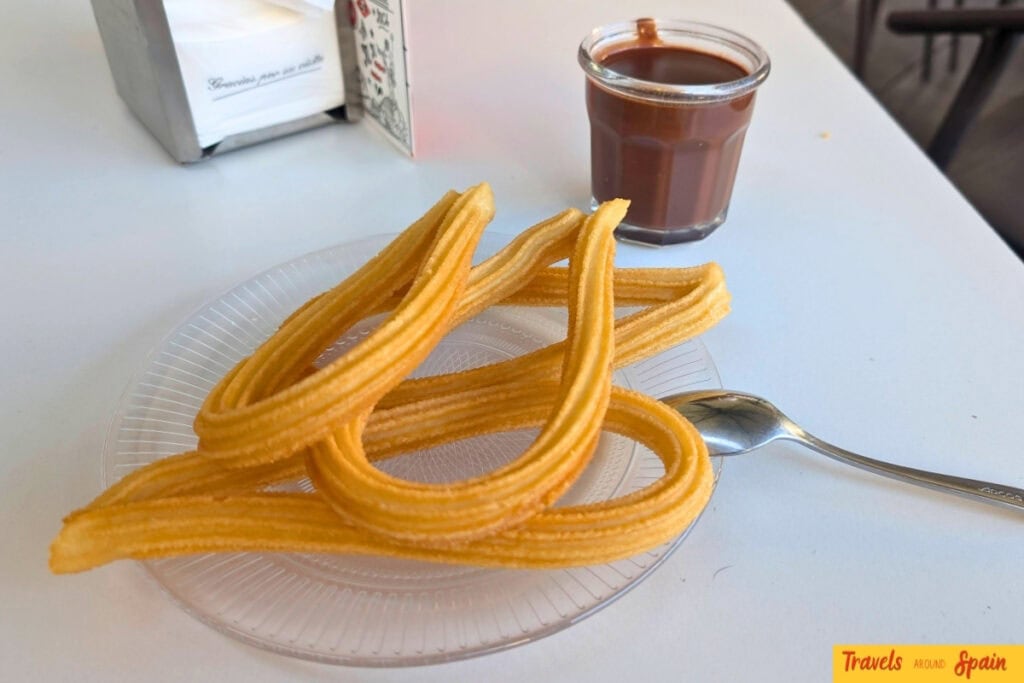 Churros and hot chocolate on a café table in Madrid in October
