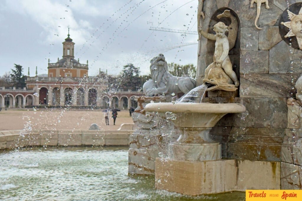 Royal Palace of Aranjuez with autumn gardens and golden trees.
