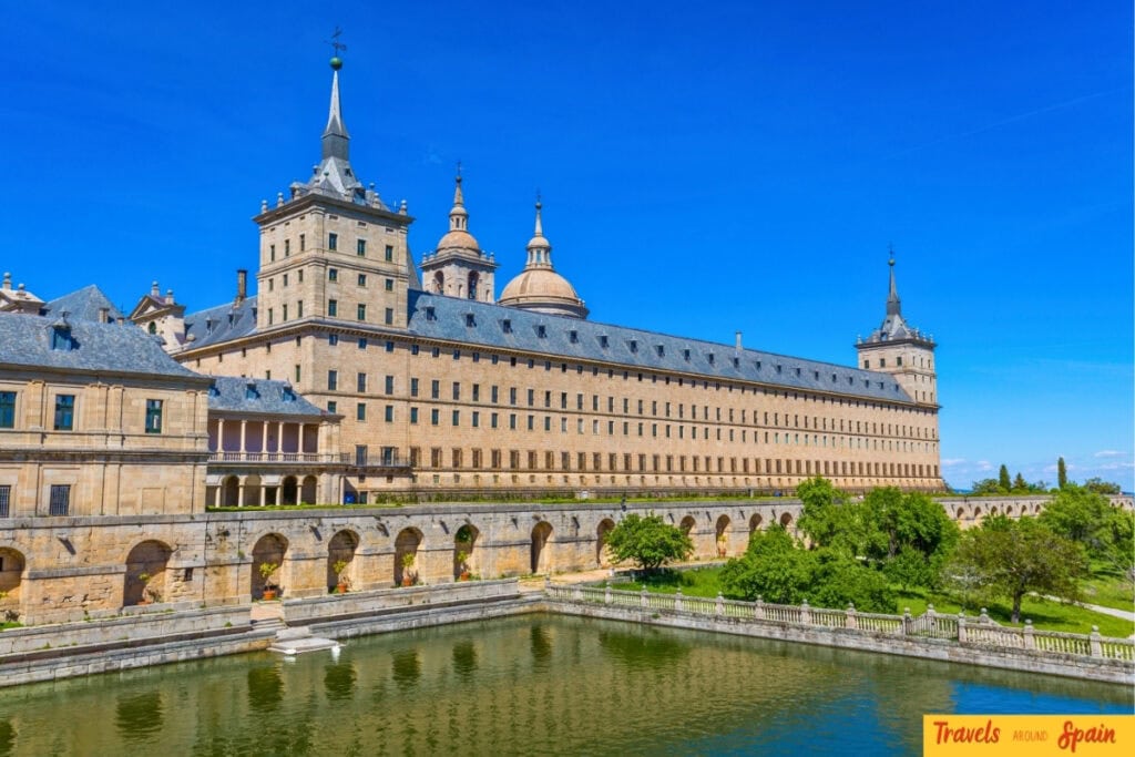 El Escorial monastery and palace surrounded by hills in autumn.