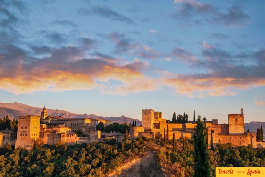 The Alhambra in Granada at sunset with Sierra Nevada mountains behind