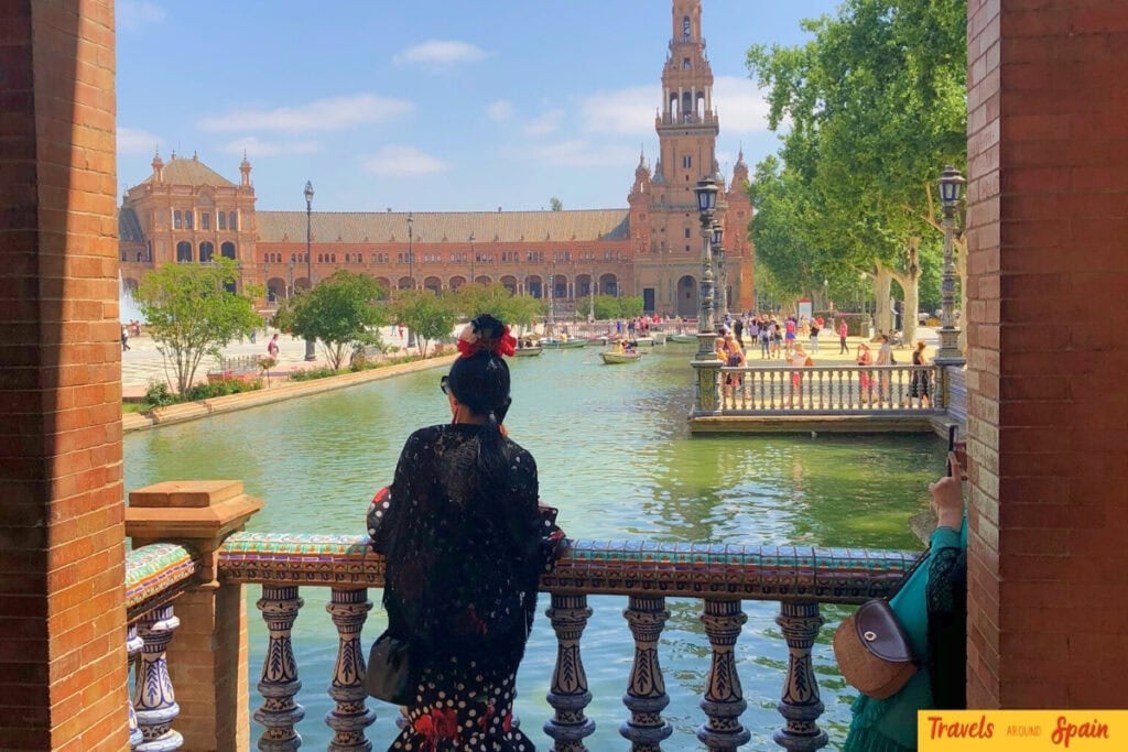 Woman in flamenco dress at Plaza de España in Seville.