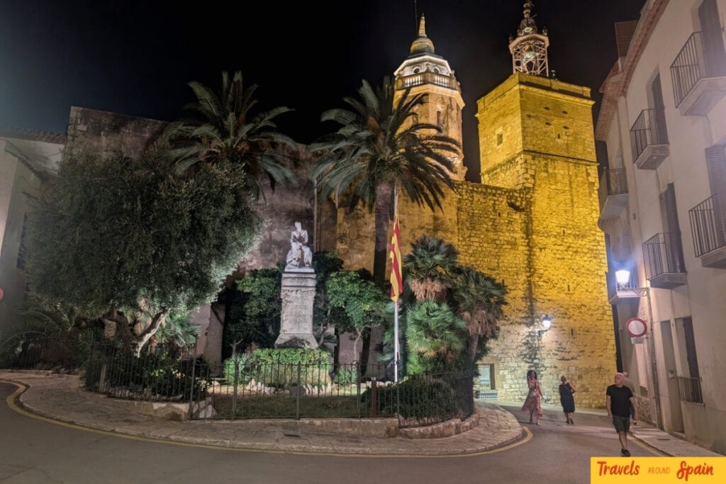 Sitges church by the sea at night during film festival season
