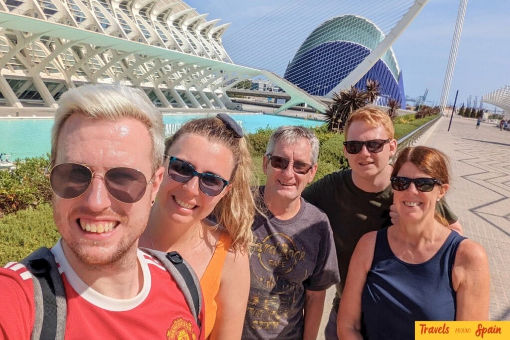 Family smiling in front of City of Arts and Sciences in Valencia Spain in September