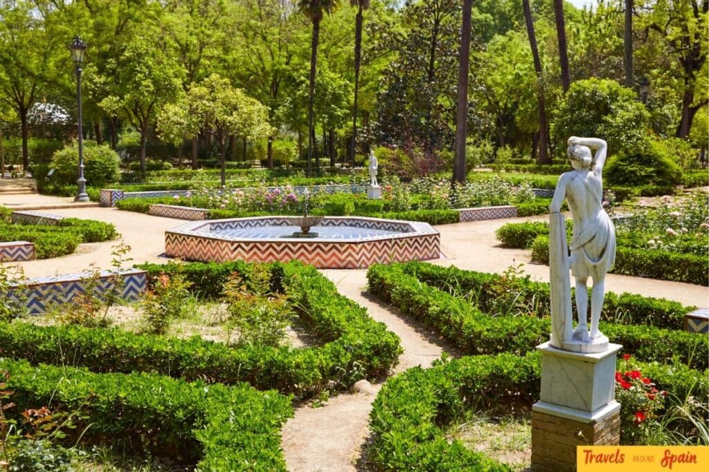 Gardens and pathways inside María Luisa Park in Seville