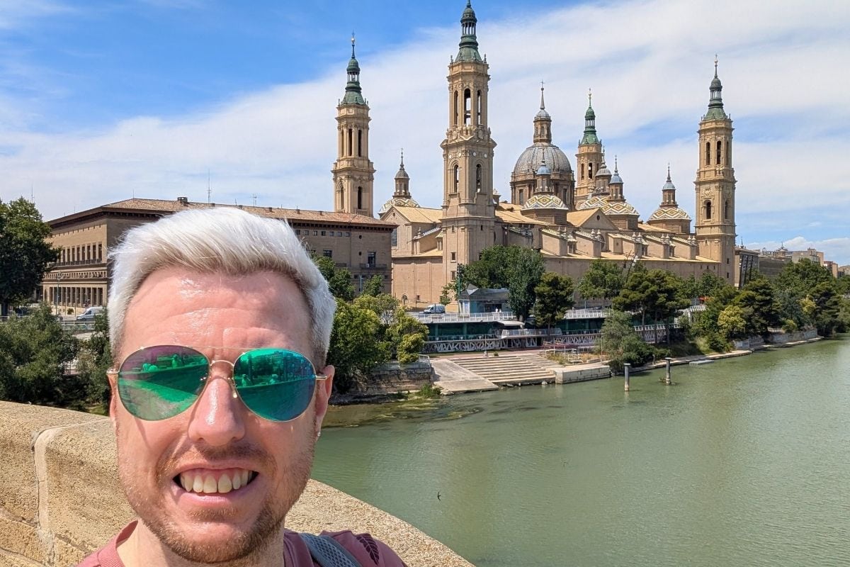 Traveller selfie beside the Ebro River with Zaragoza skyline behind