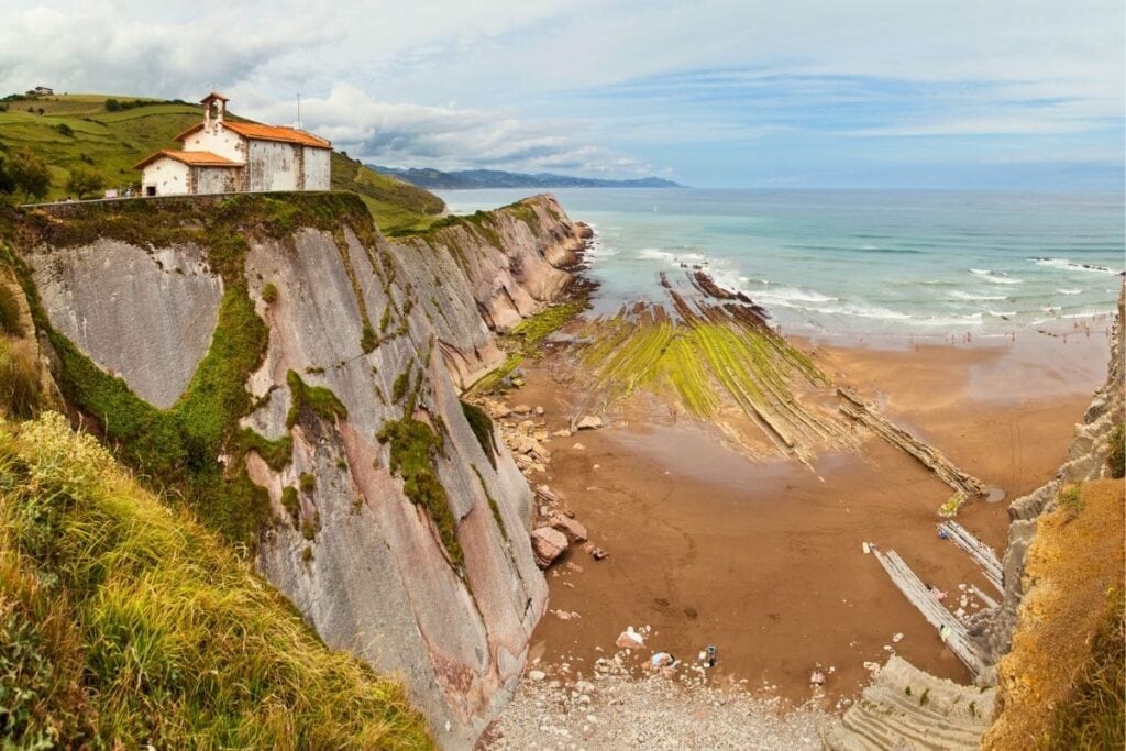 Dramatic cliffs and coastline at Itzurun Beach in Zumaia, Spain, used as Dragonstone in Game of Thrones.