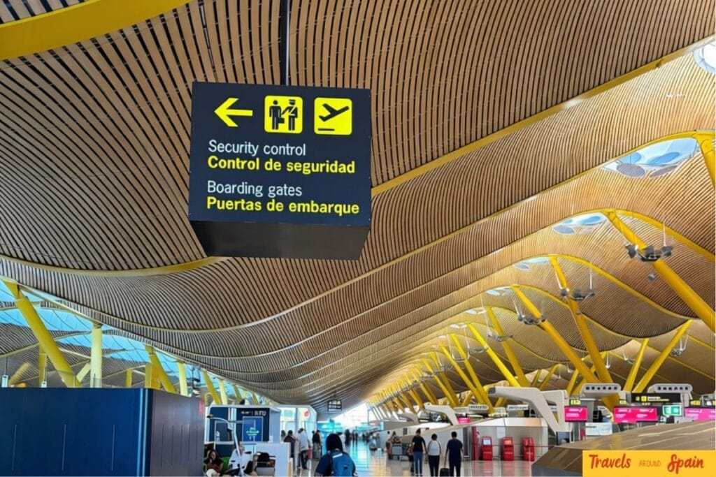 Departure signs inside Terminal 4 at Madrid-Barajas Airport.