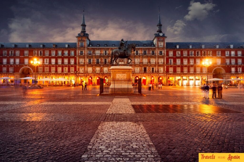 Plaza Mayor illuminated at night in Madrid, Spain.