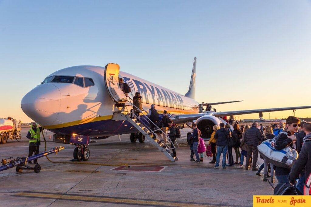 Passengers boarding a Ryanair aircraft before departure.