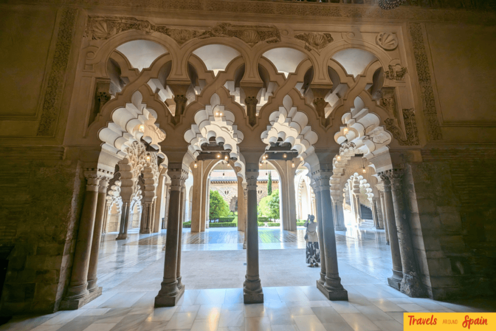 Arched columns surrounding a courtyard inside the Aljafería Palace in Zaragoza