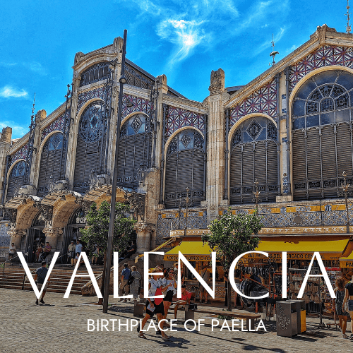 A photo of the central market in Valencia with overlay text saying Valencia in white.